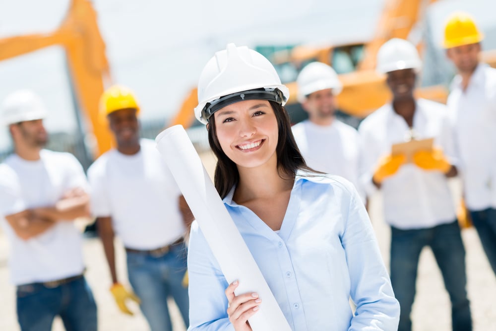 Female engineer at a construction site looking happy