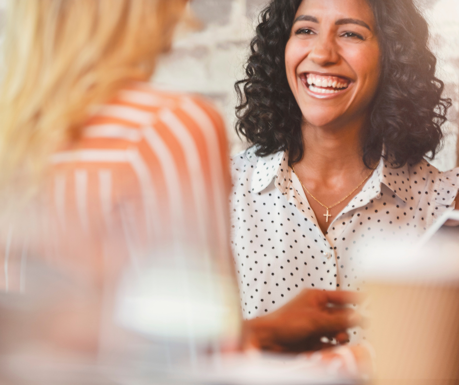 woman smiling with colleague